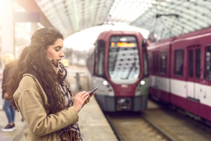 Woman at station with approaching train